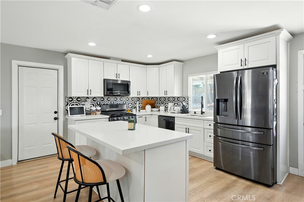 811 West James Street Rialto, CA 92376 - Photo 2 of 43 a kitchen with stainless steel appliances a refrigerator stove microwave and cabinets