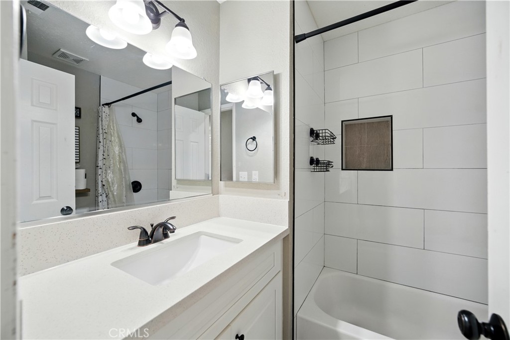 811 West James Street Rialto, CA 92376 - Photo 23 of 43 a bathroom with a tub sink and mirror
