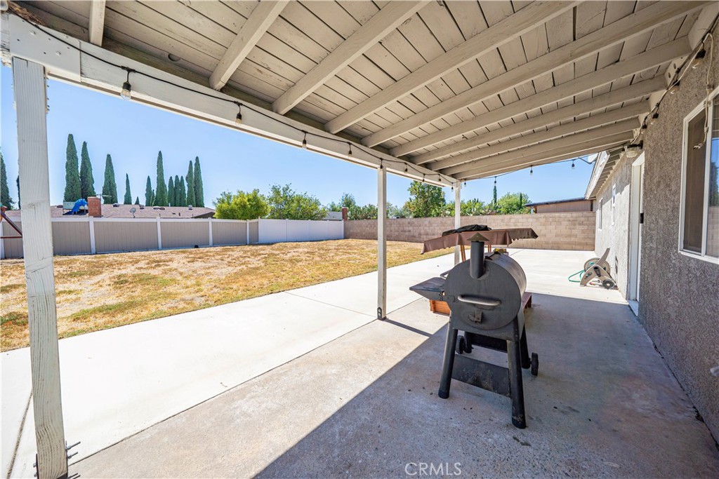 811 West James Street Rialto, CA 92376 - Photo 36 of 43 a view of a patio with table and chairs with wooden floor and fence with plants