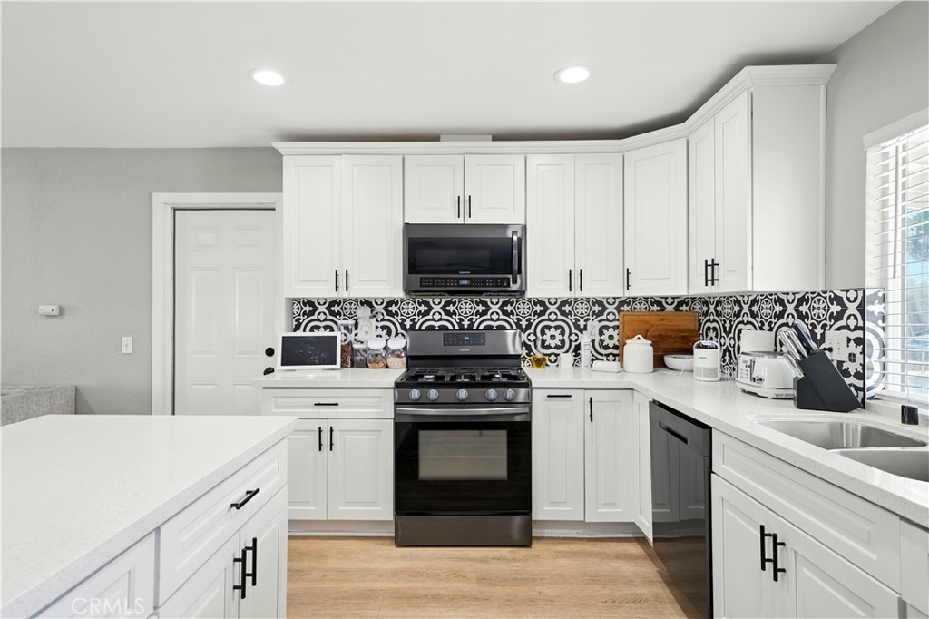 811 West James Street Rialto, CA 92376 - Photo 4 of 43 a kitchen with a stove and a sink