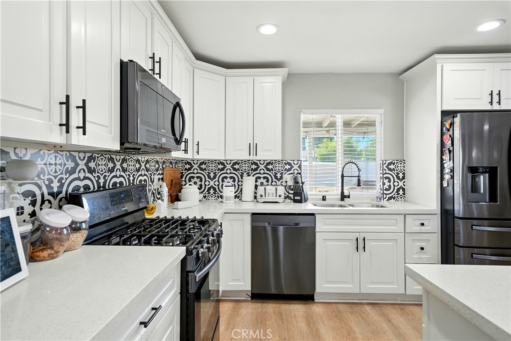811 West James Street Rialto, CA 92376 - Photo 6 of 43 a kitchen with stainless steel appliances a sink stove and refrigerator