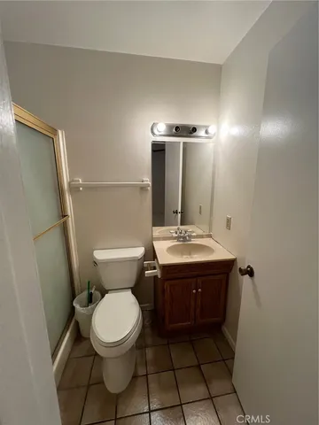 an empty room with closet and fan