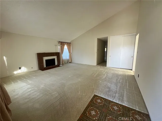 a view of empty room with a fireplace