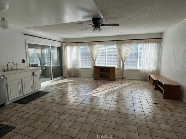 a view of empty room with window and fireplace