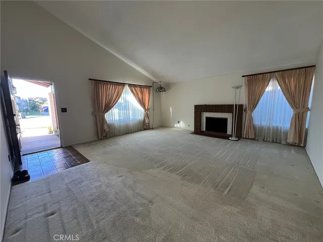 an empty room with furniture and a fireplace