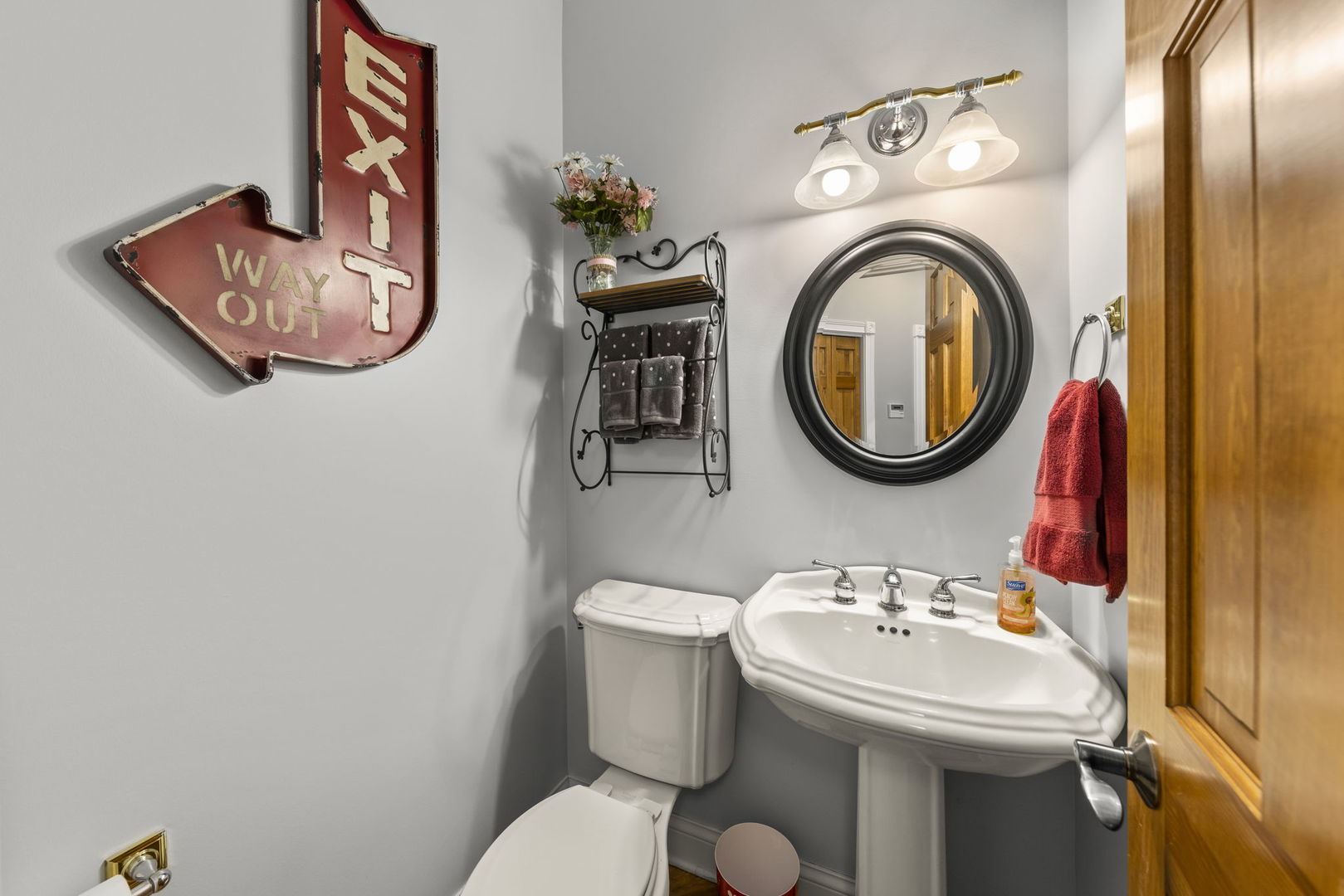 15646 Griswold Springs Road Plano, IL 60545 - Photo 15 of 46 a bathroom with a toilet a sink and a mirror