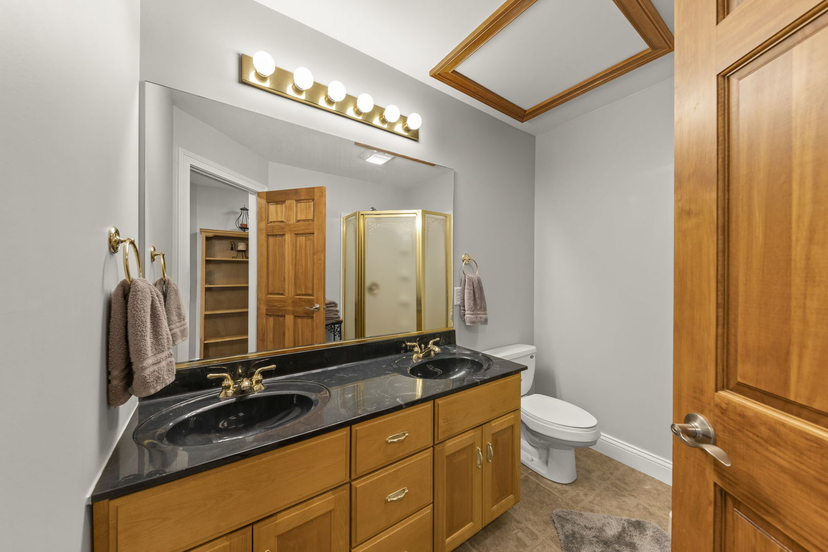 15646 Griswold Springs Road Plano, IL 60545 - Photo 21 of 46 a bathroom with a double vanity sink and a mirror