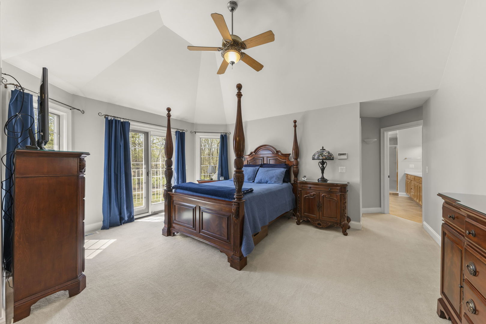 15646 Griswold Springs Road Plano, IL 60545 - Photo 22 of 46 a living room with furniture a ceiling fan a flat screen tv and a window
