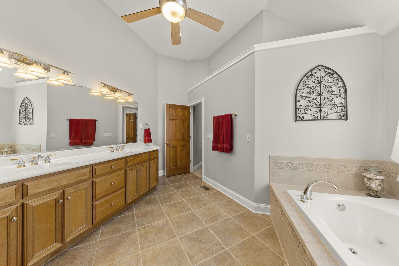 15646 Griswold Springs Road Plano, IL 60545 - Photo 25 of 46 a spacious bathroom with a tub sink and mirror