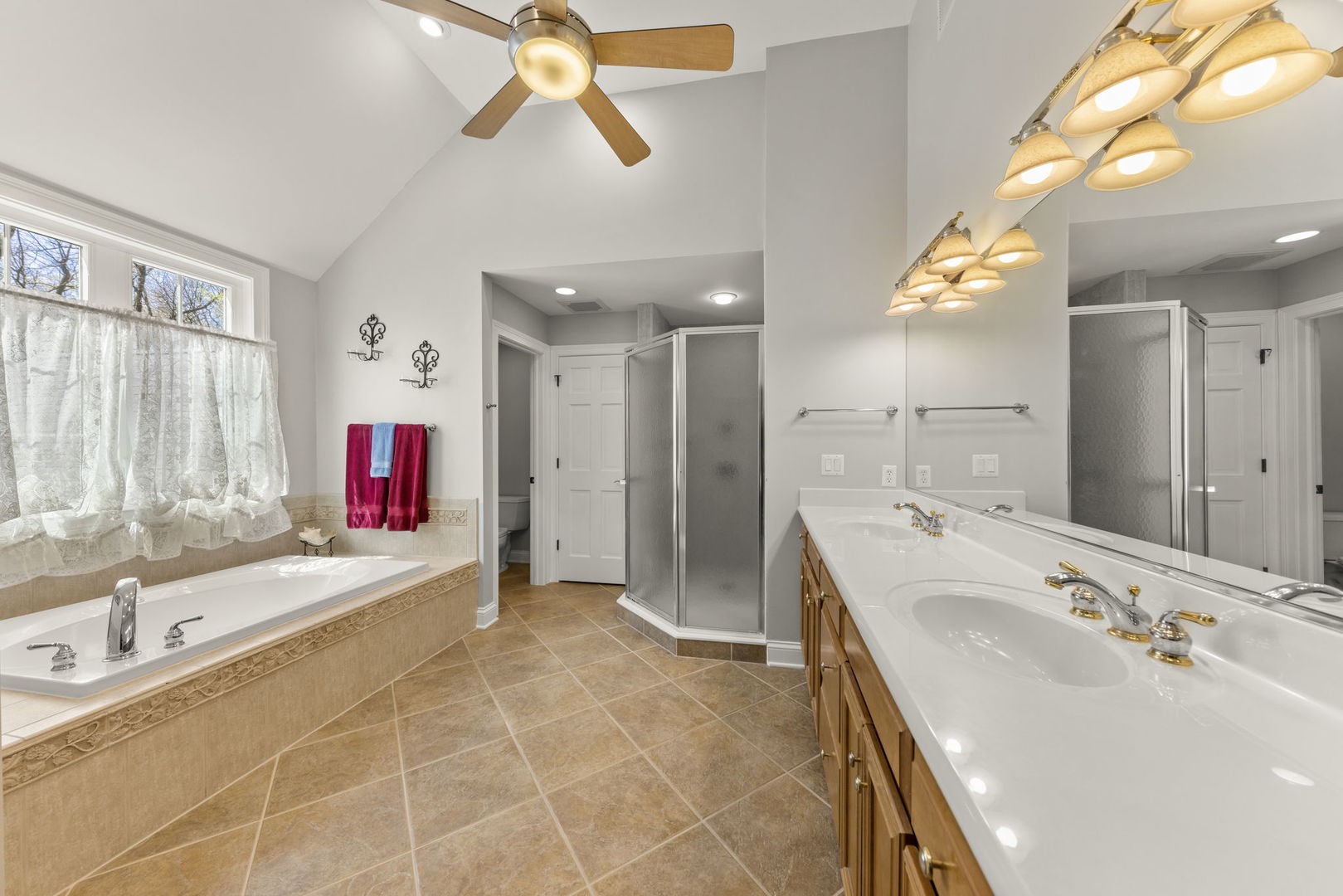 15646 Griswold Springs Road Plano, IL 60545 - Photo 26 of 46 a bathroom with a tub sink and mirror