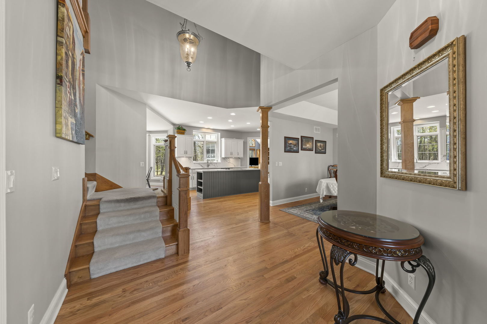 15646 Griswold Springs Road Plano, IL 60545 - Photo 3 of 46 a view of a dining room with furniture a rug and wooden floor
