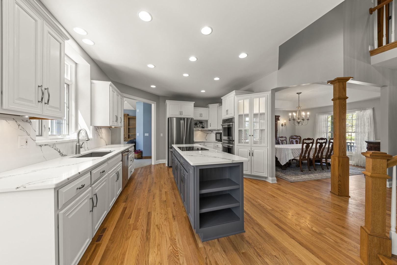 15646 Griswold Springs Road Plano, IL 60545 - Photo 6 of 46 a large kitchen with stainless steel appliances kitchen island a large counter top a stove and a wooden floors
