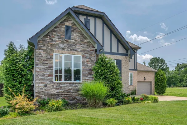 a front view of a house with garden
