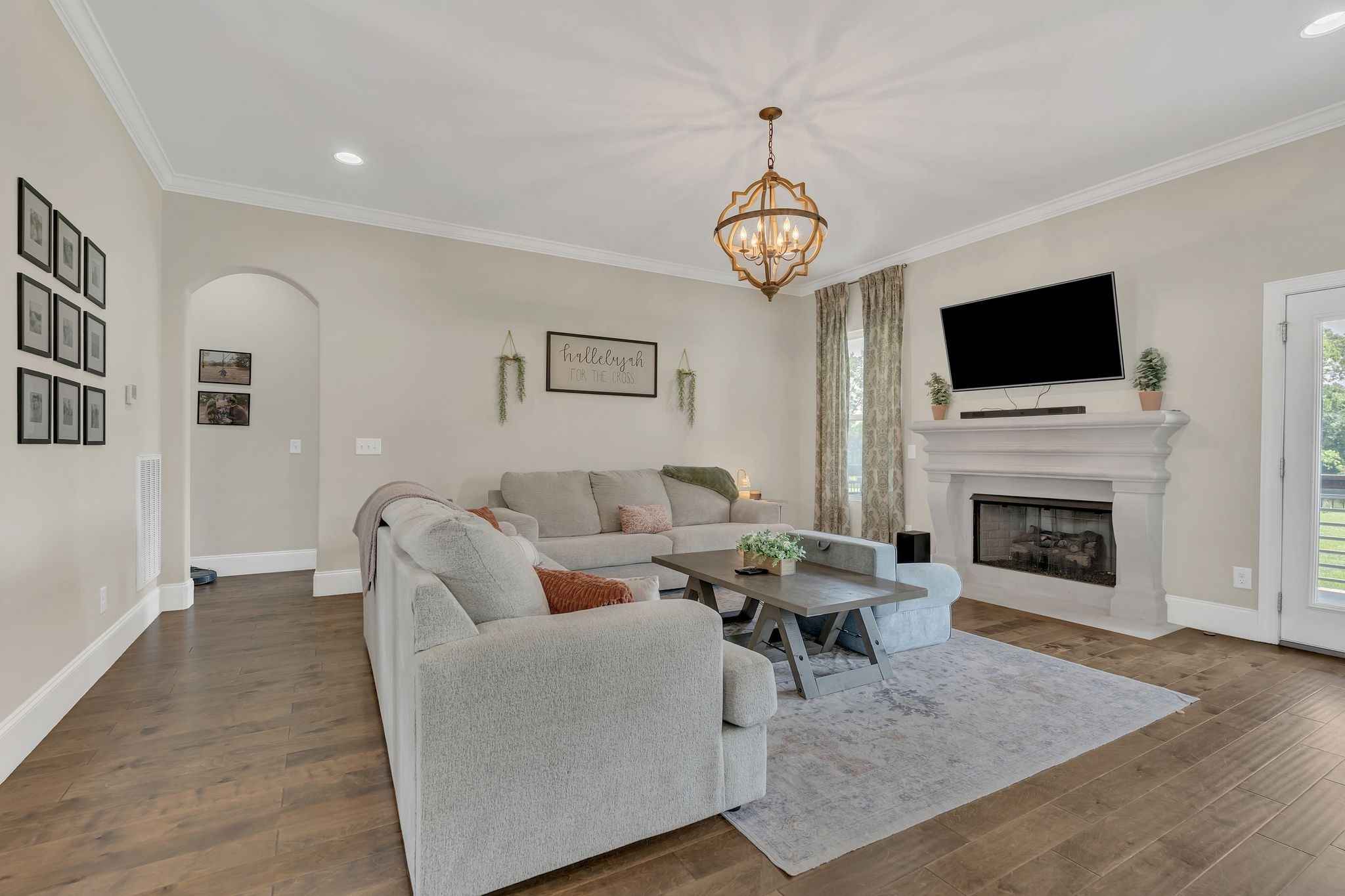 7121 Springwater Street Smyrna, TN 37167 - Photo 4 of 33 a living room with furniture a flat screen tv and a fireplace