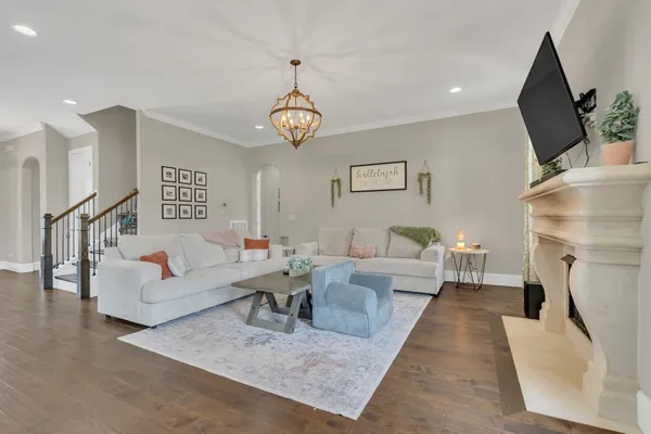 a living room with furniture wooden floor and a fireplace