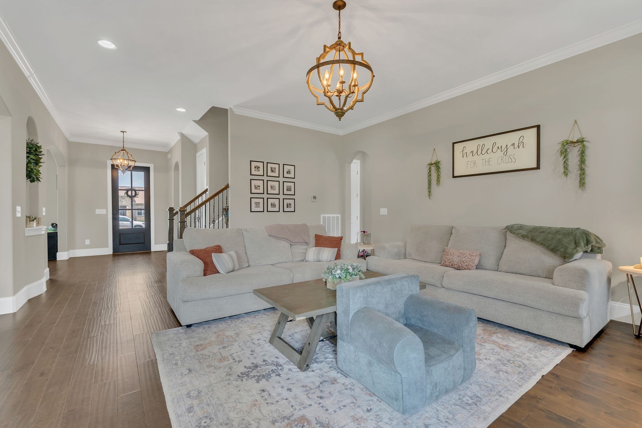 7121 Springwater Street Smyrna, TN 37167 - Photo 6 of 33 a living room with furniture and a chandelier