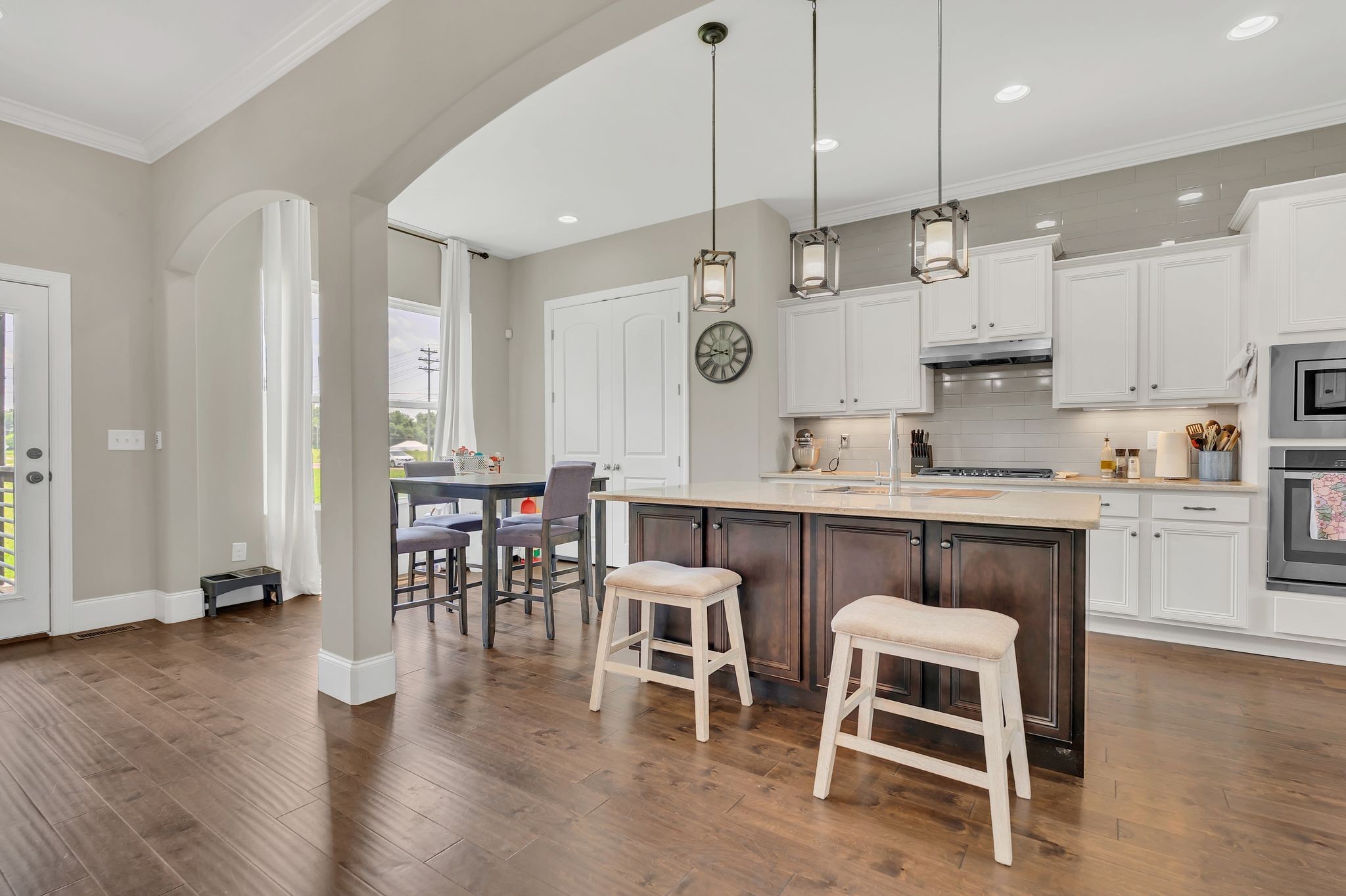 7121 Springwater Street Smyrna, TN 37167 - Photo 9 of 33 a kitchen with stainless steel appliances granite countertop a table chairs sink and cabinets