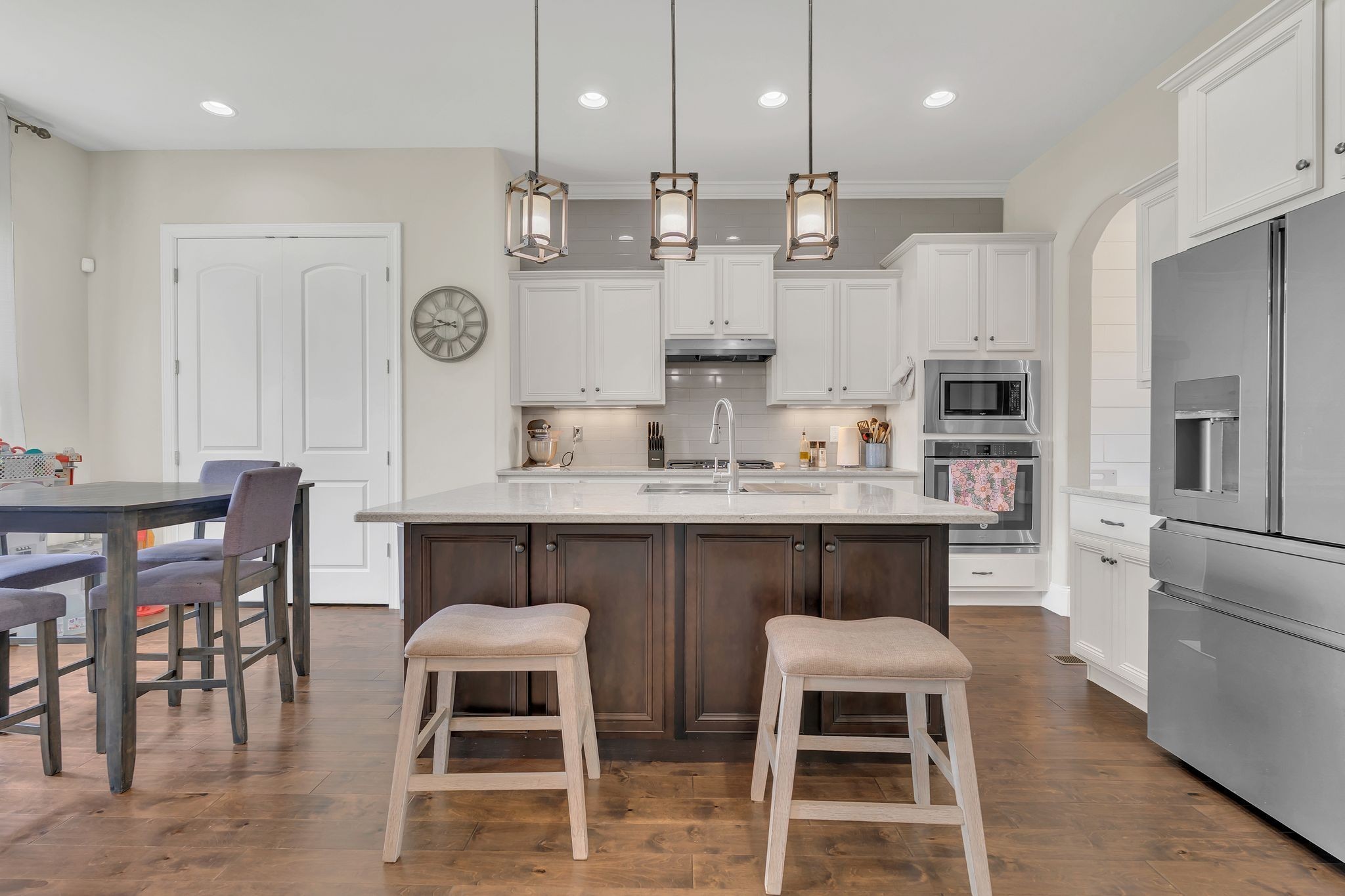 7121 Springwater Street Smyrna, TN 37167 - Photo 10 of 33 a kitchen with stainless steel appliances kitchen island granite countertop a table chairs sink and cabinets