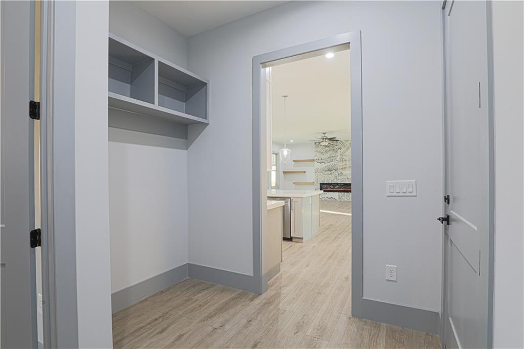 1341 Wheeler Creek Road Maysville, GA 30558 - Photo 20 of 51 a view of a hallway with wooden floor and a bathroom