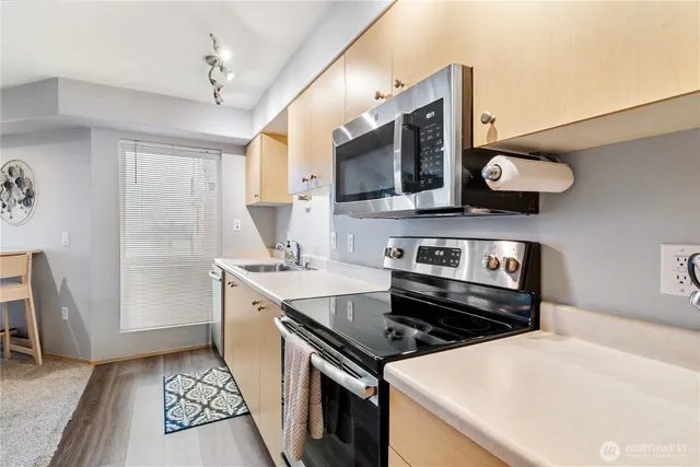 a kitchen with stainless steel appliances granite countertop a stove and a sink