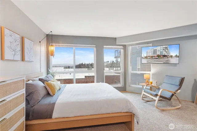 a bedroom with furniture and a large window