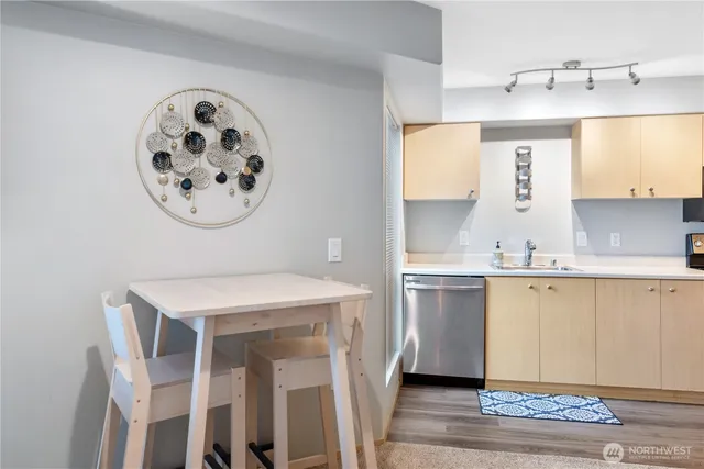 a kitchen with a refrigerator a sink and a stove top oven