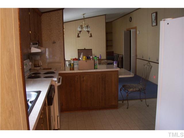 4258 Piney Grove Road Angier, NC 27501 - Photo 3 of 6 a kitchen with a refrigerator and a sink