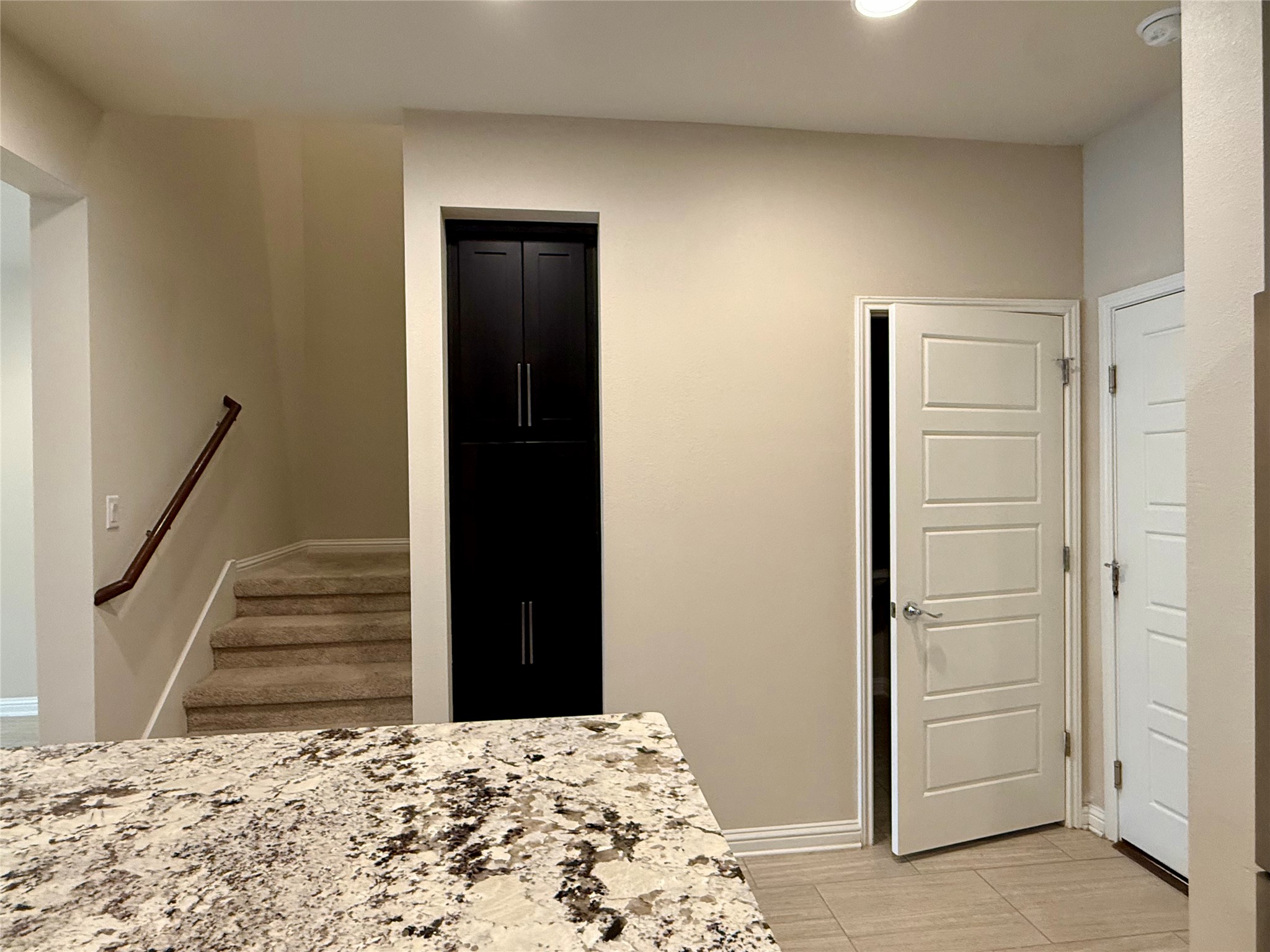 6814 East Riverside Drive, Unit 73 Austin, TX 78741 - Photo 12 of 33 Multi-level layout featuring a carpeted staircase with a wood handrail