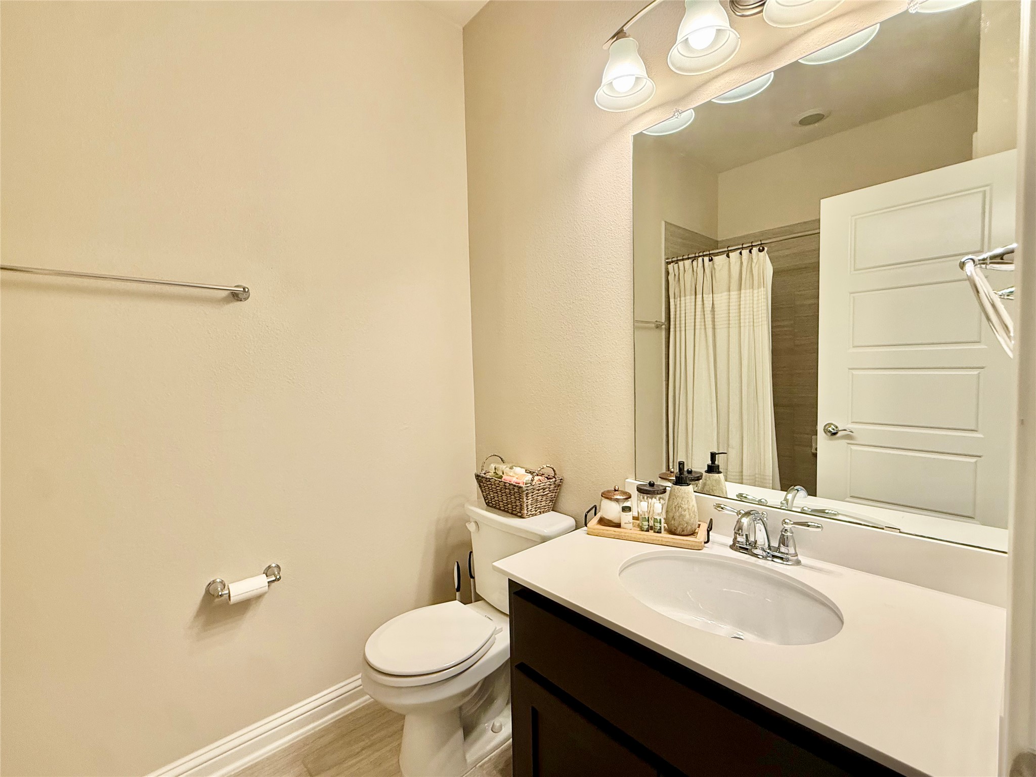 6814 East Riverside Drive, Unit 73 Austin, TX 78741 - Photo 21 of 33 Bathroom featuring a single vanity with an integrated sink, dark wood-finish cabinetry, and a light-toned countertop