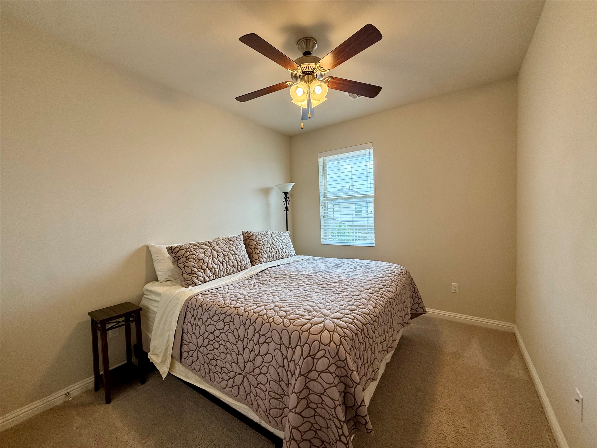6814 East Riverside Drive, Unit 73 Austin, TX 78741 - Photo 23 of 33 Bedroom with neutral-toned walls, a single window featuring horizontal blinds, and a ceiling fan with integrated lighting
