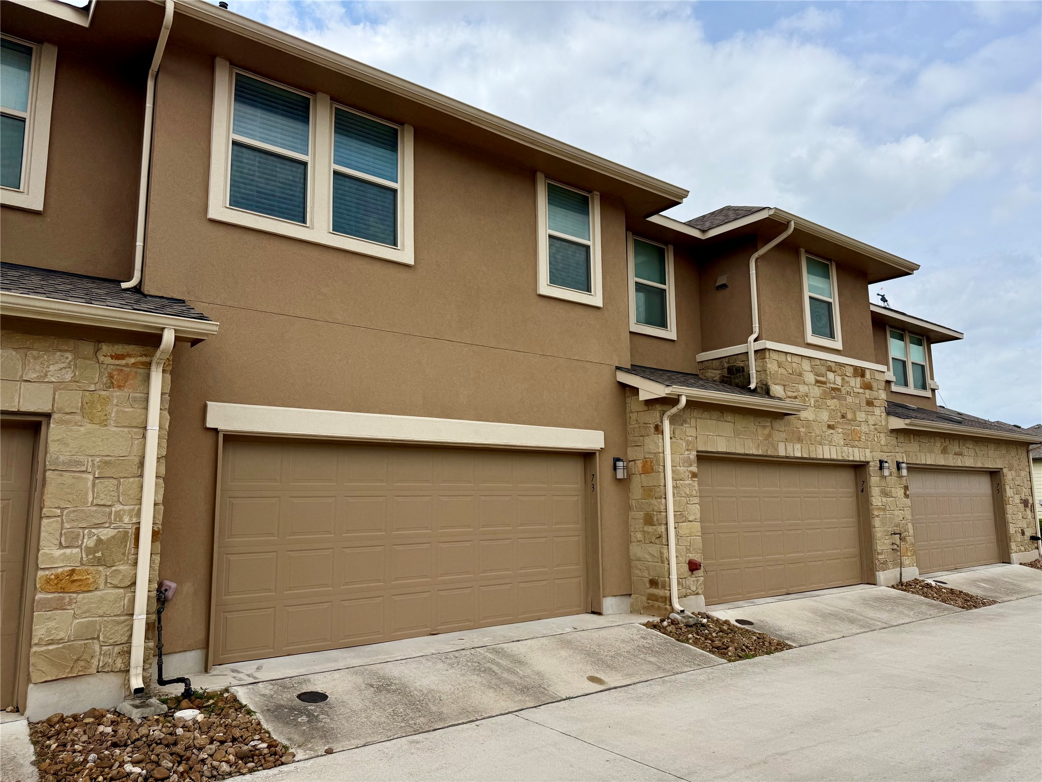 6814 East Riverside Drive, Unit 73 Austin, TX 78741 - Photo 29 of 33 Multi-story exterior featuring stucco and stone veneer finishes