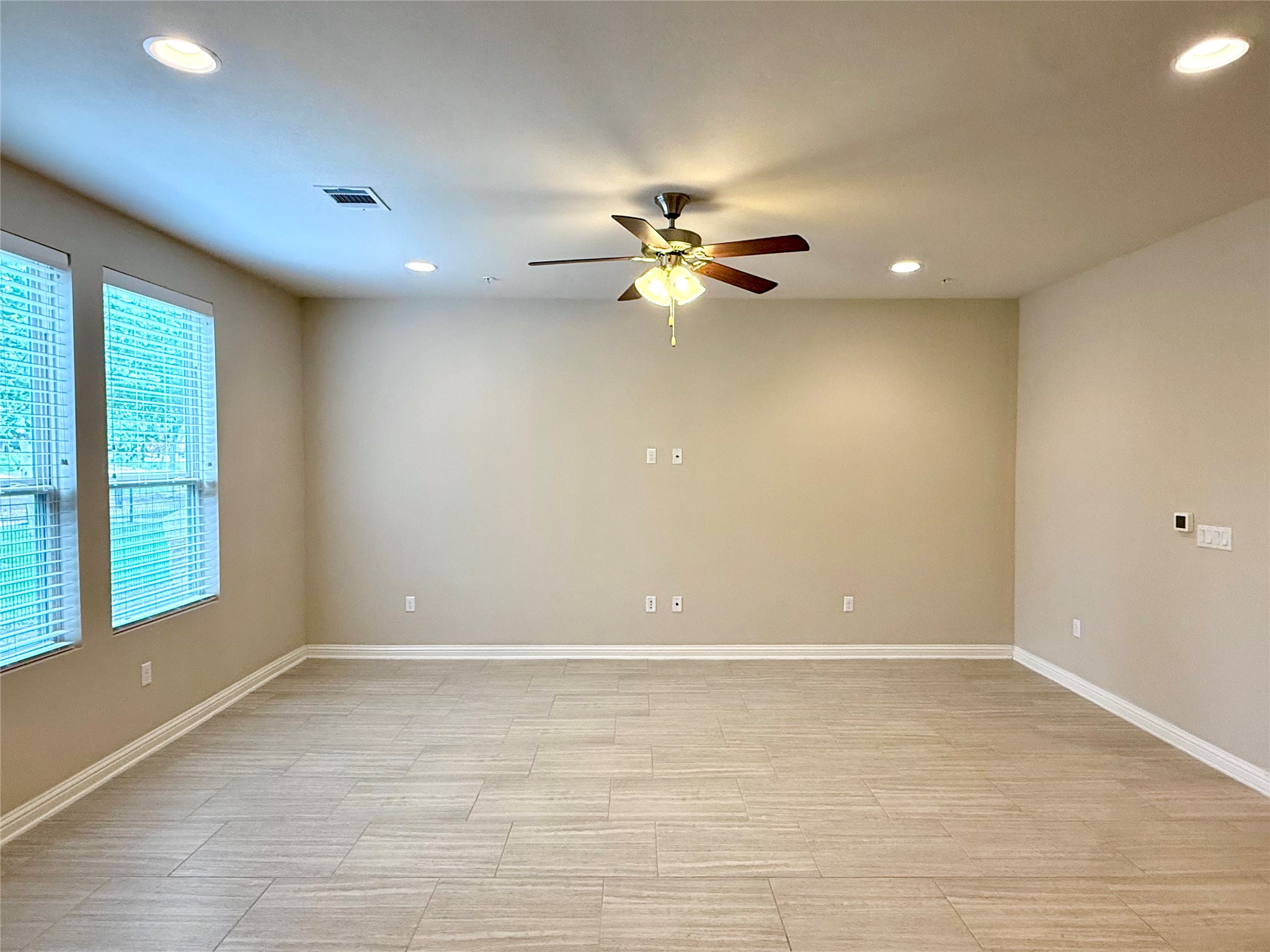 6814 East Riverside Drive, Unit 73 Austin, TX 78741 - Photo 7 of 33 Spacious room featuring neutral paint, recessed lighting, and a ceiling fan