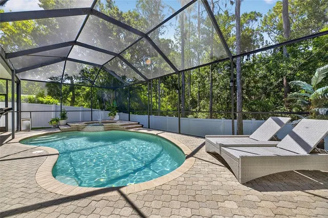 an aerial view of residential houses with outdoor space and trees