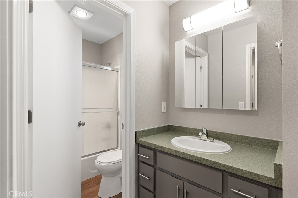 2159 Elm Street, Unit 2 Chico, CA 95928 - Photo 16 of 28 a bathroom with a granite countertop sink toilet and mirror