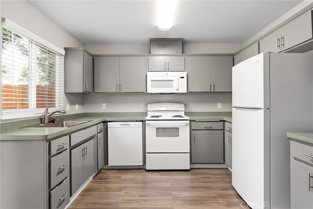 2159 Elm Street, Unit 2 Chico, CA 95928 - Photo 4 of 28 a kitchen with a white cabinets and white appliances