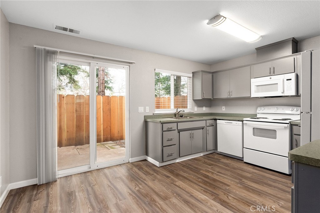 2159 Elm Street, Unit 2 Chico, CA 95928 - Photo 5 of 28 a kitchen with stainless steel appliances granite countertop a stove a sink and a refrigerator