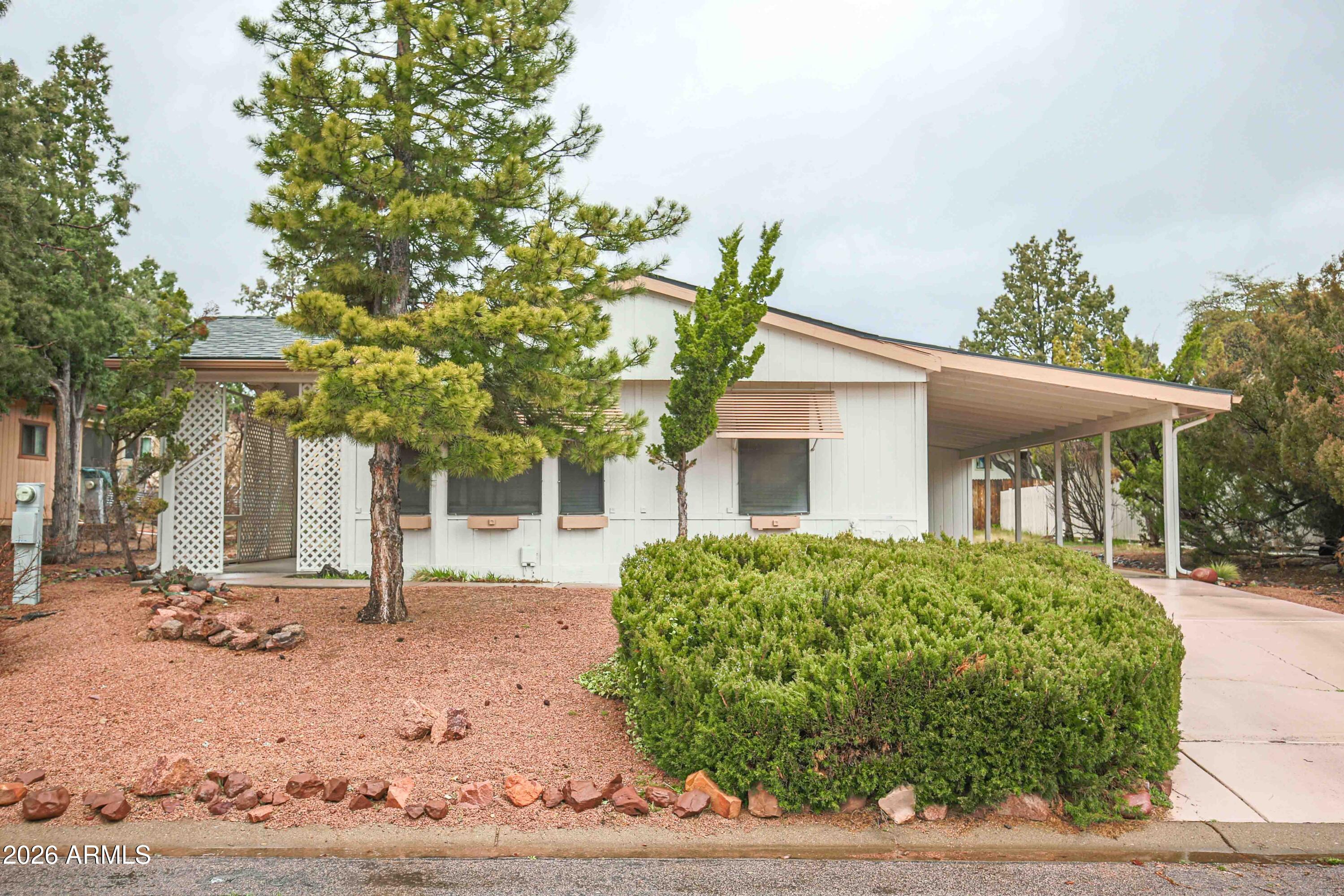 a front view of a house with a tree