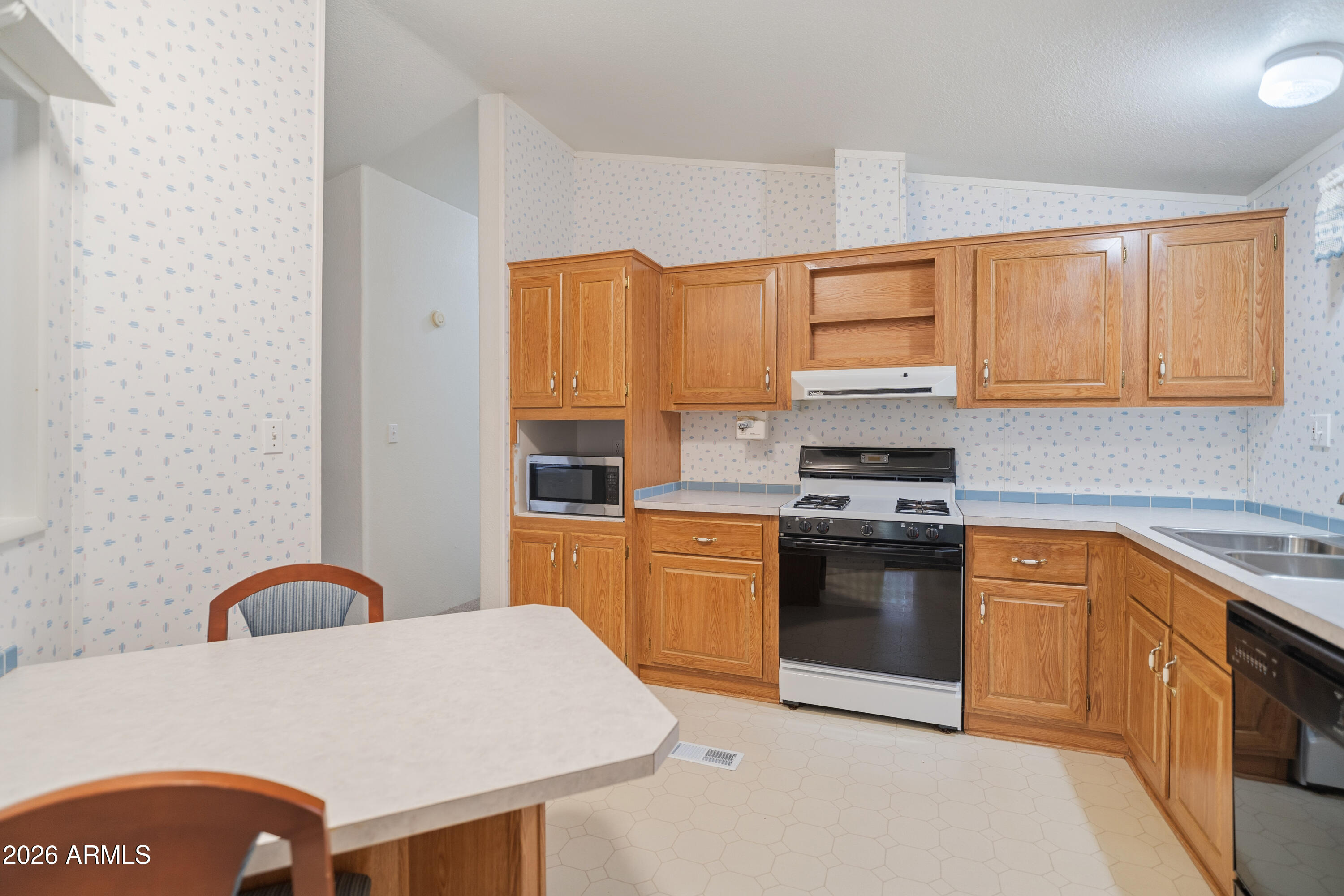 1106 West Crestview Drive Payson, AZ 85541 - Photo 18 of 24 a kitchen with stainless steel appliances granite countertop a stove a sink dishwasher and a microwave