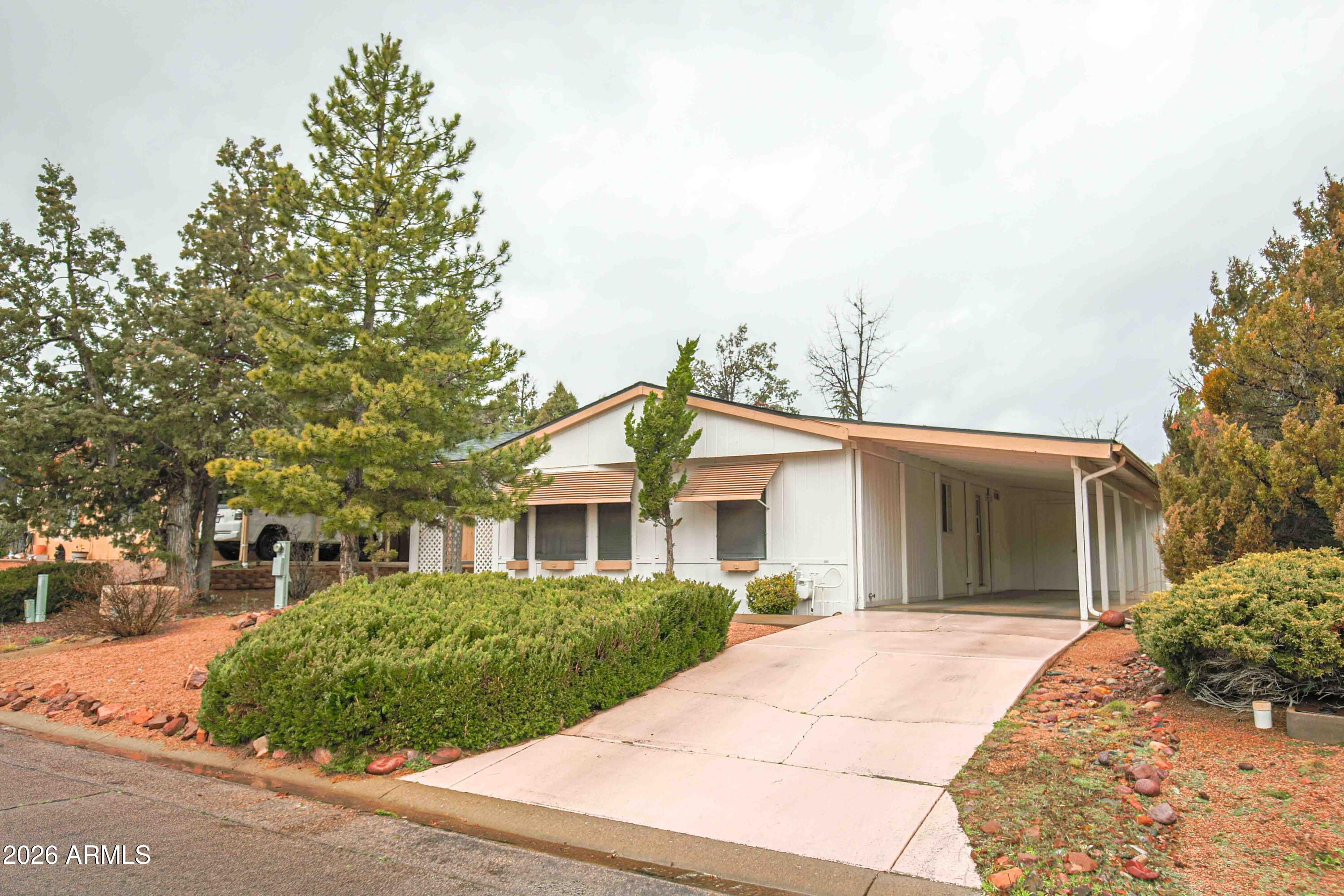 1106 West Crestview Drive Payson, AZ 85541 - Photo 2 of 24 a front view of a house with a garden
