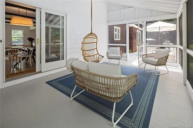 a view of a house with backyard and sitting area