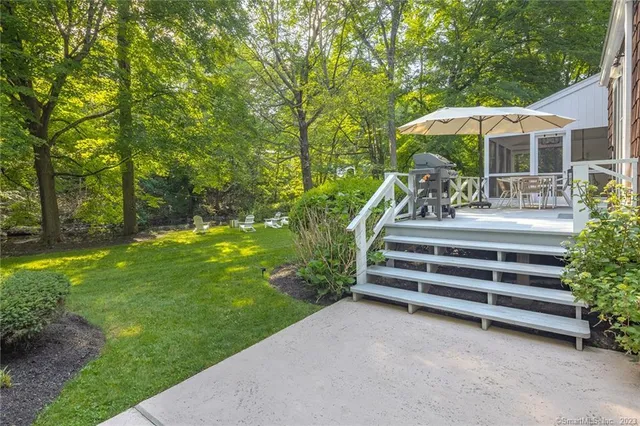 a view of a table and chairs under an umbrella in the patio