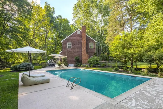 a front view of house with a garden