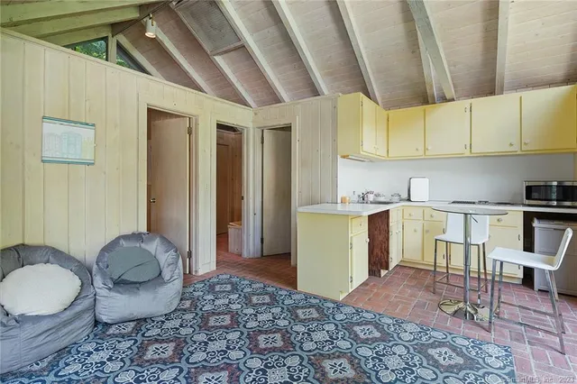 a view of a swimming pool with lawn chairs and a big yard