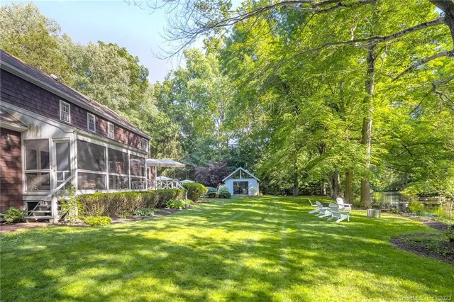 a view of a house with backyard porch and sitting area