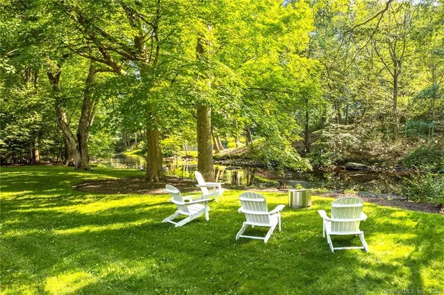 a view of a yard with a house and large trees