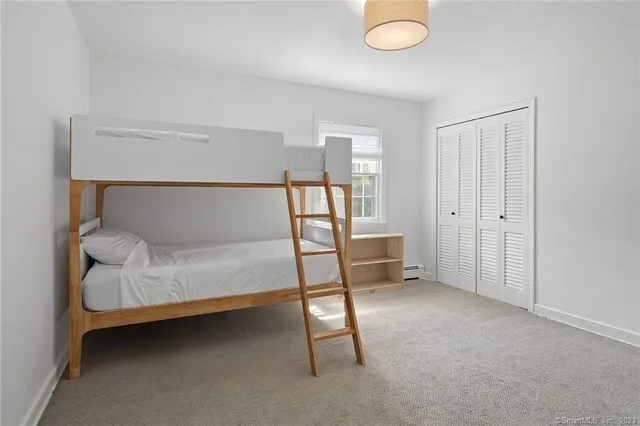 a bedroom with a bed and flat screen tv