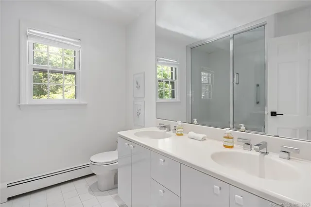 a bedroom with two beds and a table chair