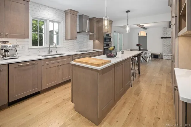 a kitchen with a sink a counter top space a stove and cabinets