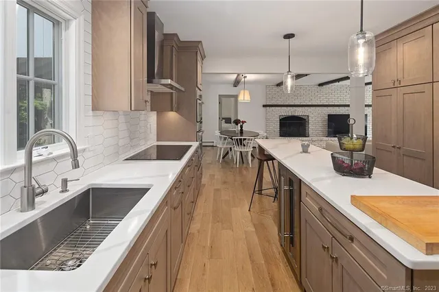 a kitchen with stainless steel appliances granite countertop a sink a stove and a refrigerator