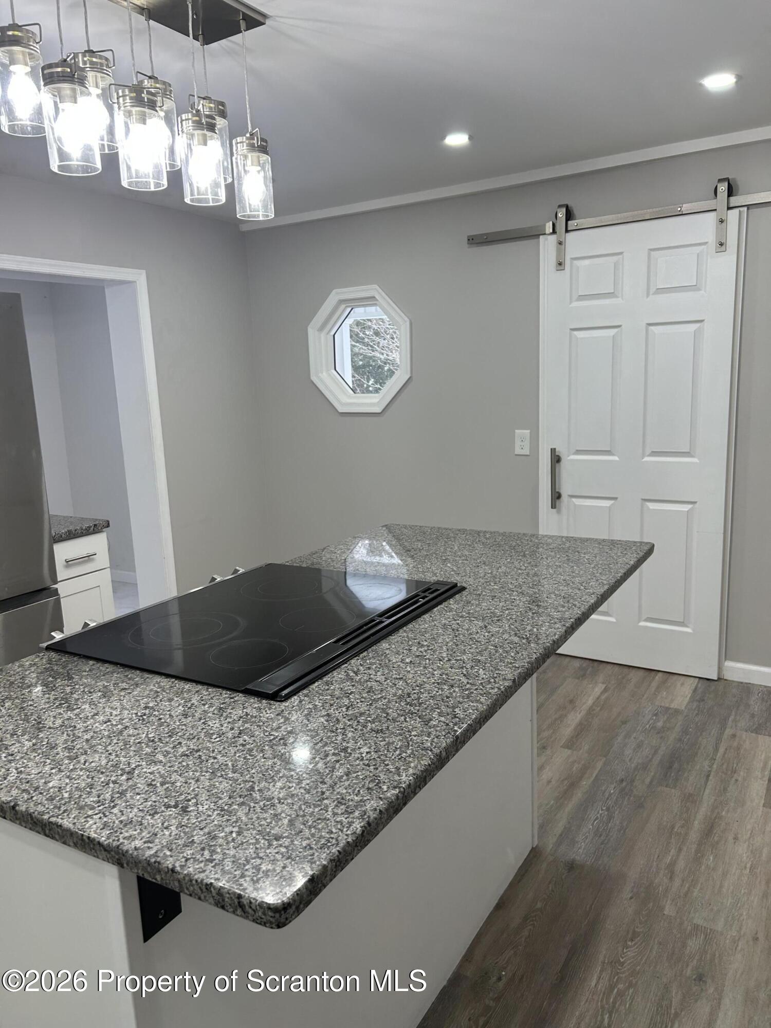 337 Wayne Street Archbald, PA 18403 - Photo 12 of 26 a kitchen with a granite counter top and a chandelier